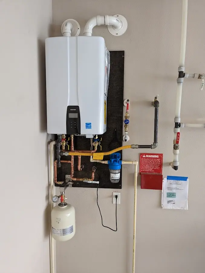 Professional plumber installing copper piping in a St. Helens home